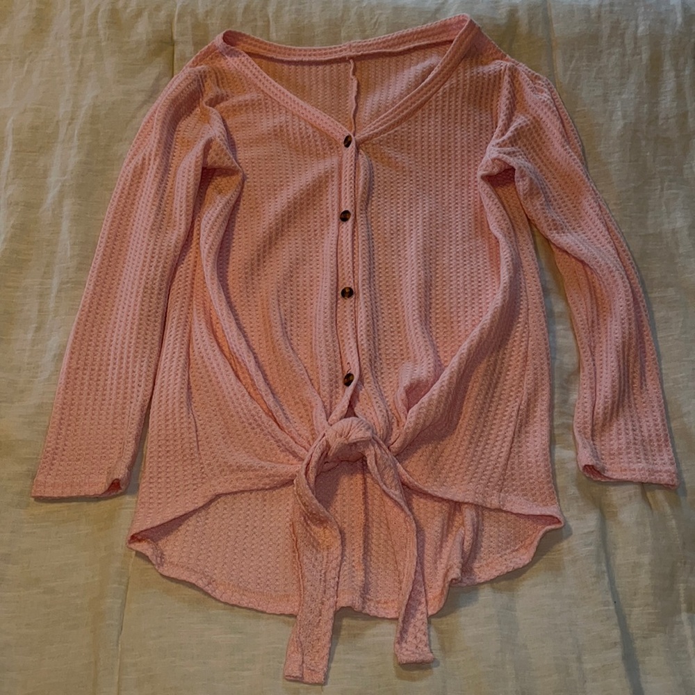 Pink waffle long sleeve knit button up with tie bottom.